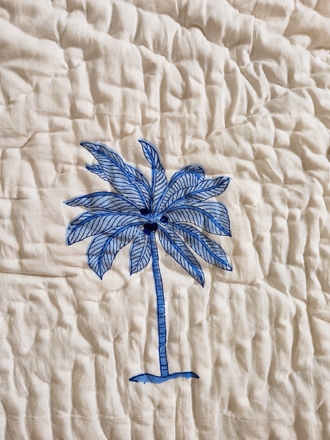 Macro detail of Sagar quilt palm tree motif on quilted cotton