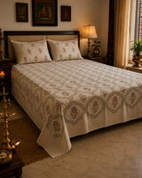 Kusumrekha champagne floral hand block printed king bedsheet on bed