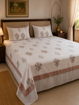 Gulmohar terracotta floral hand block printed king bedsheet on bed