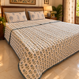 Phulwari quilt on bed, side angle